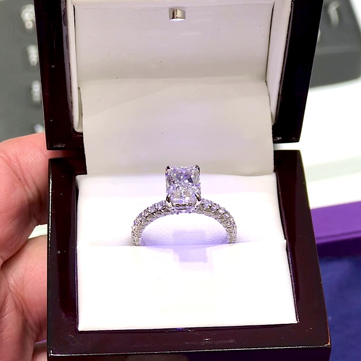 18kt White Gold Engagement Ring with 2.5 carat natural diamond at the center (Color: D | Clarity: VS1 | Radiant Cut) and 1.5 carats natural E / VVS grade Setting Diamonds. Three Dimensional Shank with Hidden Halo Setting.